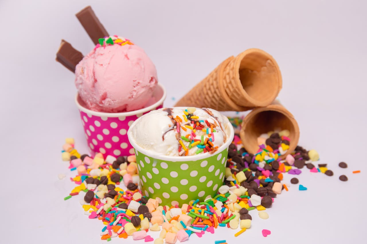 services-04 Delicious ice cream in vibrant cups with scattered sprinkles and waffle cones.