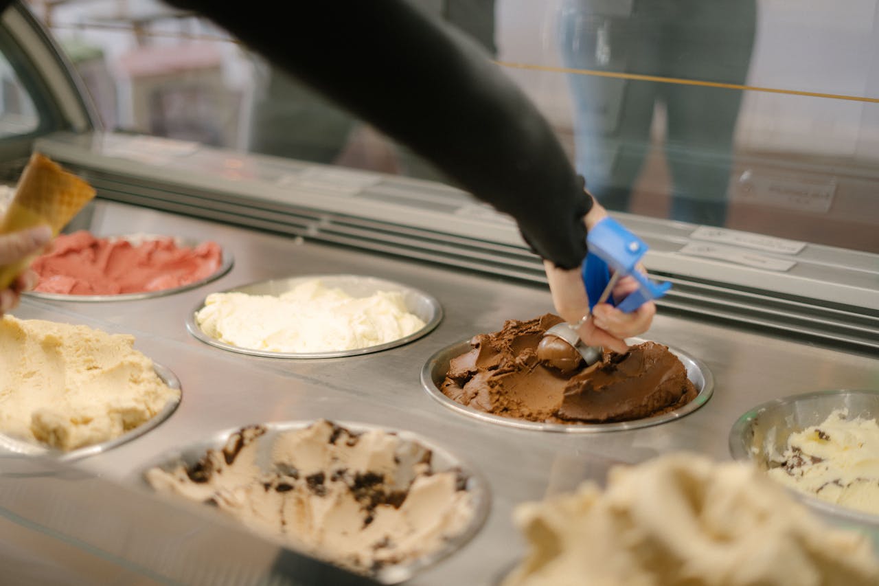 services-02 A hand scoops chocolate ice cream in a vibrant gelato shop in Perth, Australia. Indulge your sweet tooth.
